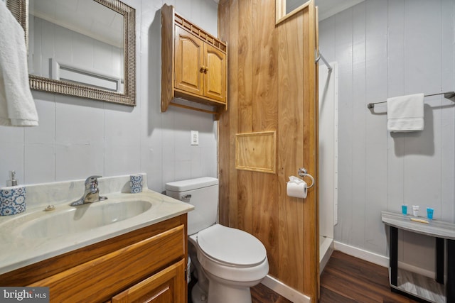 bathroom featuring vanity, hardwood / wood-style floors, toilet, and walk in shower