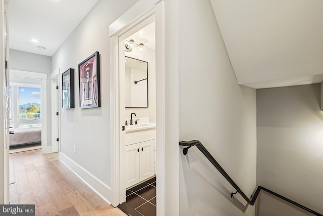 corridor featuring light hardwood / wood-style floors and sink