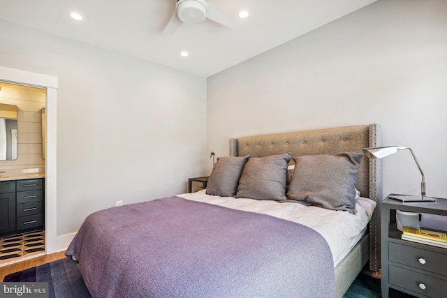 bedroom with hardwood / wood-style flooring, connected bathroom, and ceiling fan