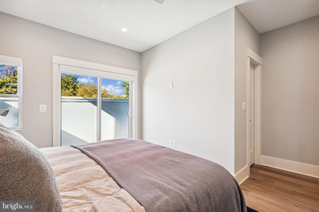 bedroom featuring hardwood / wood-style floors and access to outside