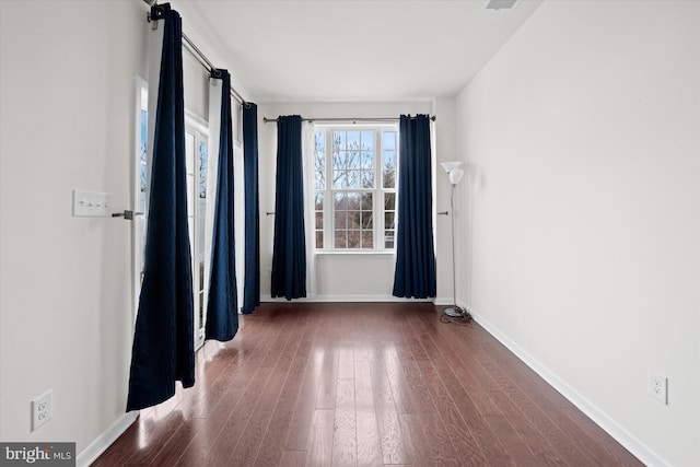 spare room featuring dark hardwood / wood-style flooring