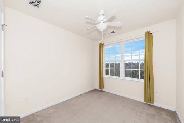 carpeted spare room featuring ceiling fan