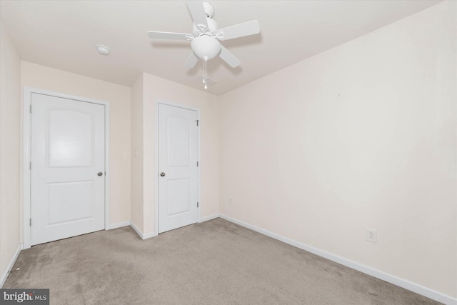 unfurnished bedroom with light colored carpet and ceiling fan