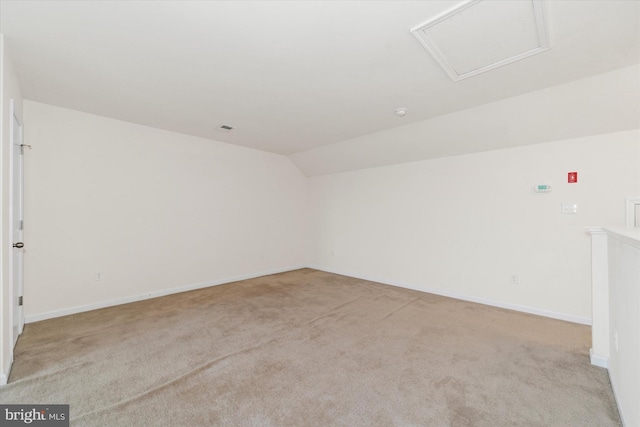 empty room with light carpet and vaulted ceiling