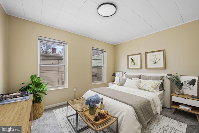 bedroom with light carpet and baseboards