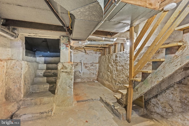 unfinished basement featuring stairway