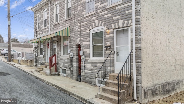 entrance to property with stone siding