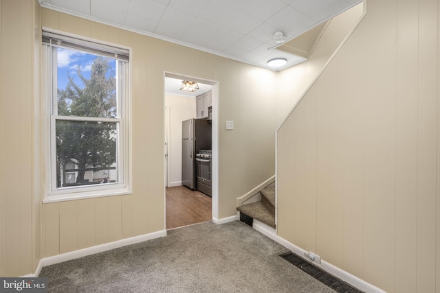 stairs featuring ornamental molding, carpet flooring, and baseboards