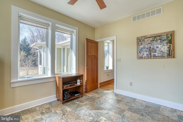 entrance foyer featuring a healthy amount of sunlight, visible vents, and baseboards