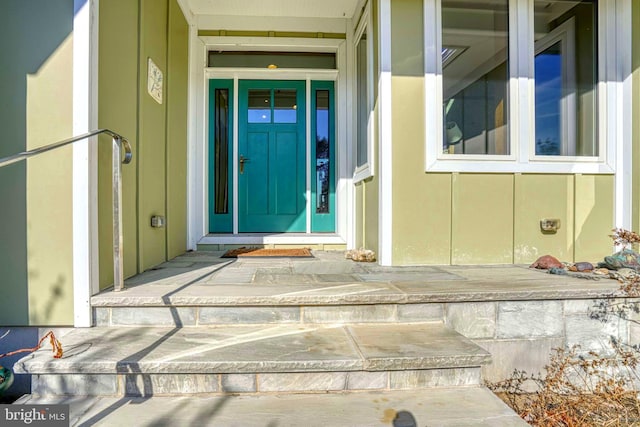 entrance to property featuring board and batten siding