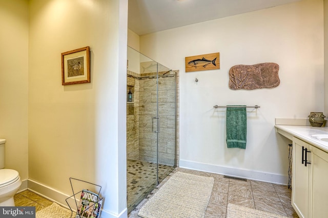 full bathroom with a stall shower, toilet, and baseboards