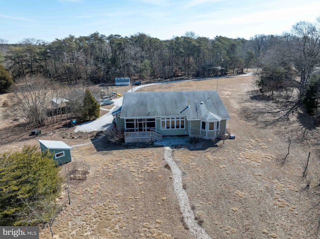 birds eye view of property featuring a view of trees