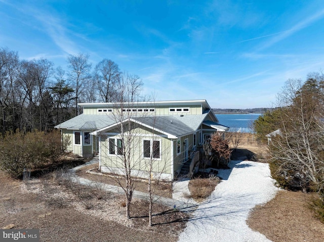 view of side of property featuring board and batten siding and a shingled roof