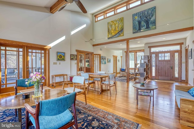 interior space featuring beam ceiling, ceiling fan, and wood finished floors