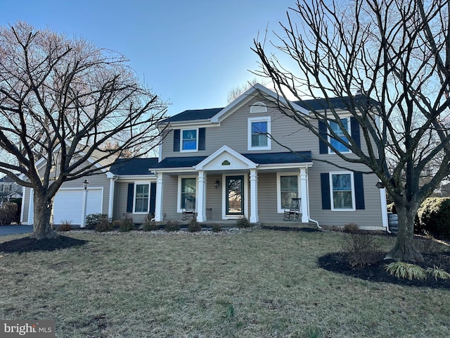 view of front facade with a front lawn and a garage