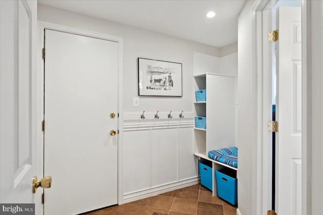 interior space featuring dark tile patterned floors and recessed lighting