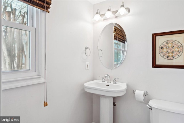 bathroom with toilet and a sink