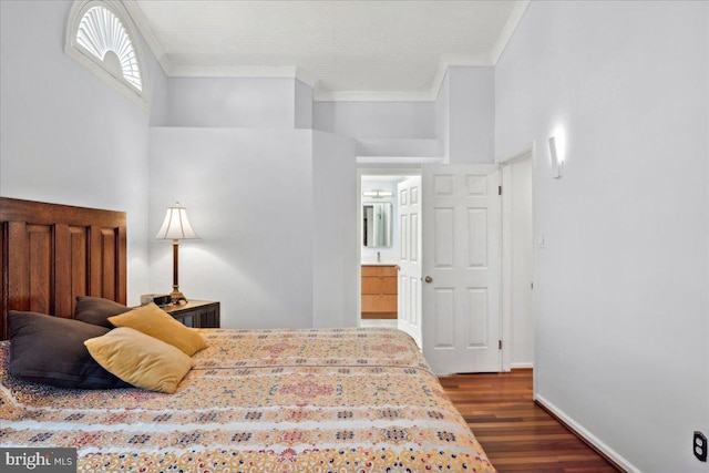 bedroom with crown molding, baseboards, and dark wood-style flooring