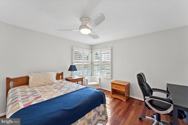 bedroom featuring baseboards, hardwood / wood-style floors, and a ceiling fan