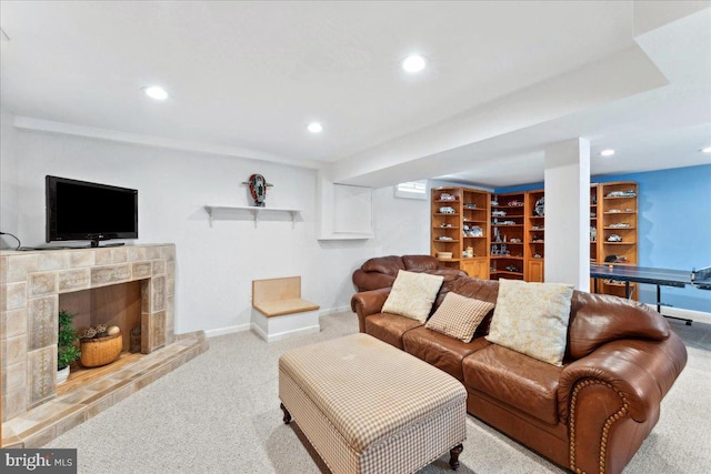 carpeted living room with recessed lighting, baseboards, and a fireplace with raised hearth