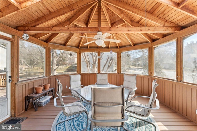 sunroom / solarium featuring lofted ceiling with beams, wooden ceiling, and ceiling fan