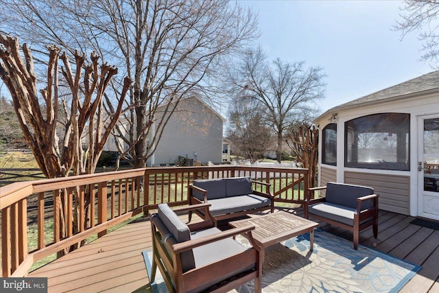 deck with outdoor lounge area and a sunroom