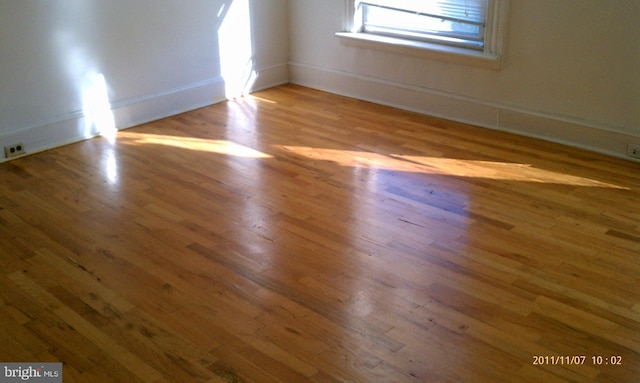 unfurnished room with light wood-type flooring