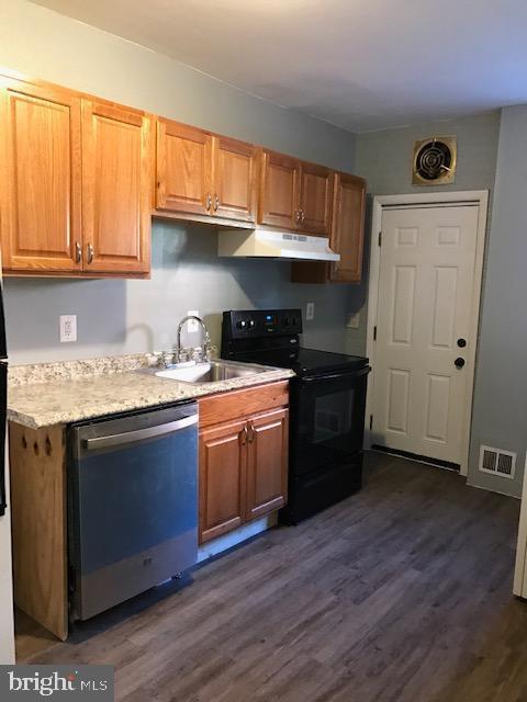 kitchen featuring sink, black electric range, dishwasher, and dark hardwood / wood-style flooring