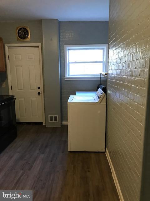 laundry area featuring dark hardwood / wood-style flooring