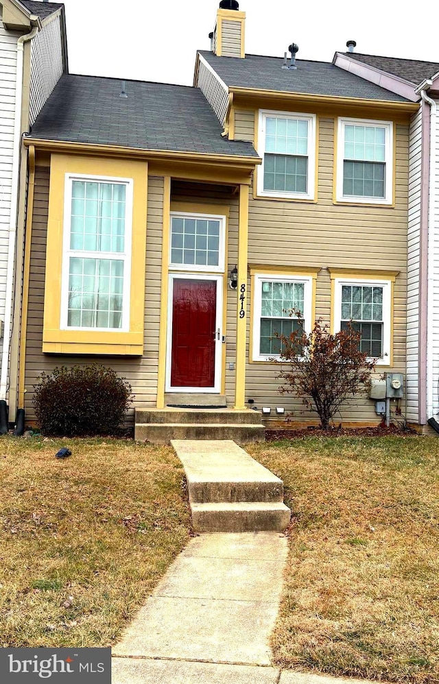 entrance to property with a yard