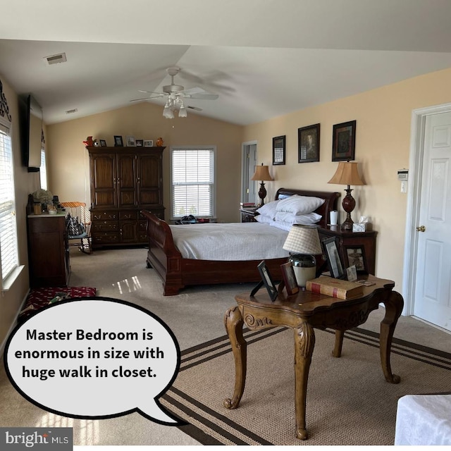 bedroom featuring light carpet, vaulted ceiling, and ceiling fan