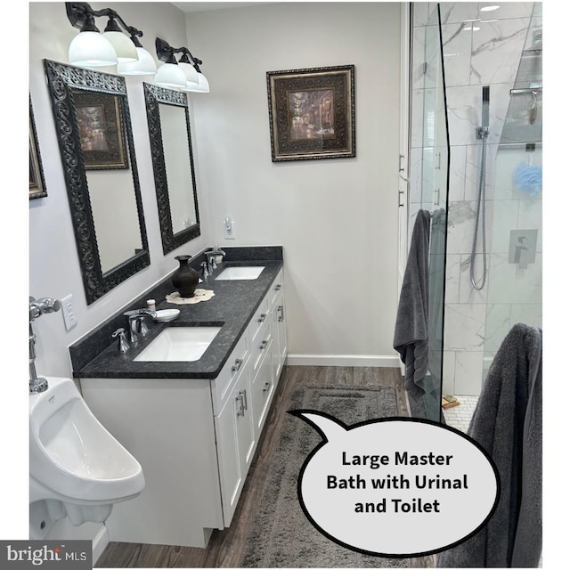 bathroom with hardwood / wood-style flooring, a shower with door, and vanity