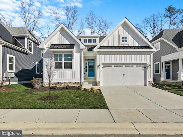 modern inspired farmhouse featuring a garage, driveway, board and batten siding, a standing seam roof, and a front yard