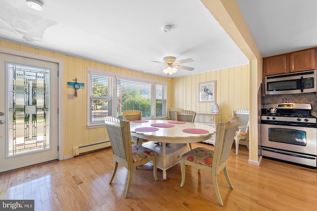 dining space featuring light hardwood / wood-style flooring, ceiling fan, and baseboard heating