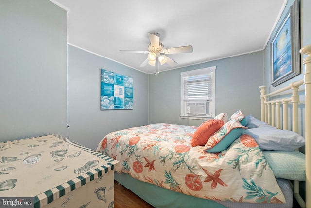 bedroom with ornamental molding, ceiling fan, cooling unit, and wood-type flooring