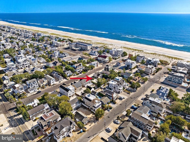 birds eye view of property with a beach view and a water view