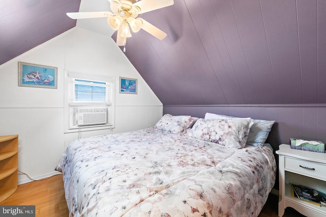 bedroom featuring cooling unit, light wood-type flooring, and vaulted ceiling