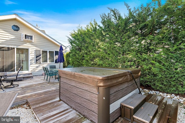 wooden terrace with a hot tub