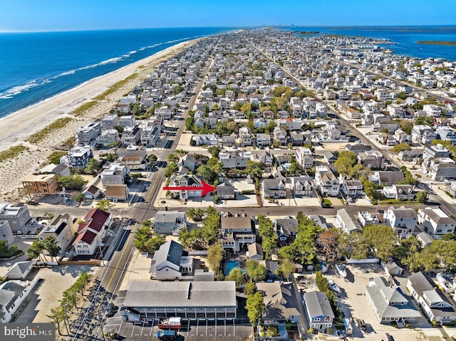 drone / aerial view featuring a water view and a beach view