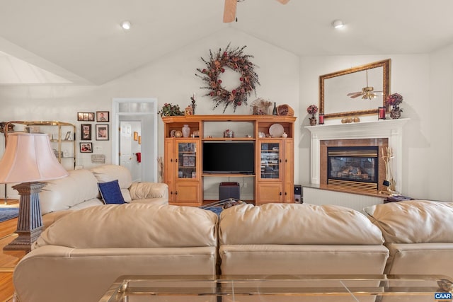 living room featuring wood-type flooring, lofted ceiling, and ceiling fan