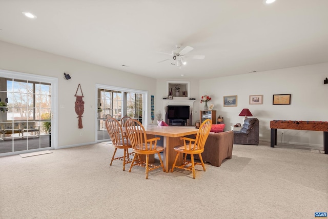 carpeted dining space featuring ceiling fan