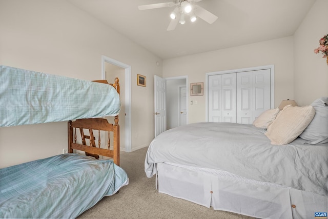 bedroom featuring a closet, light colored carpet, and ceiling fan