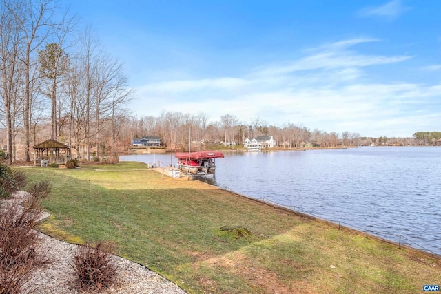 dock area featuring a lawn, a water view, and a gazebo