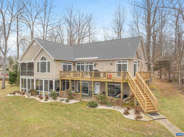 back of property with a yard, a wooden deck, and a sunroom