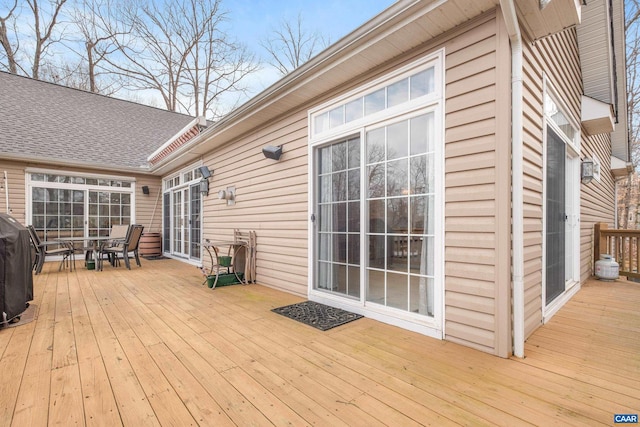 wooden terrace with a grill