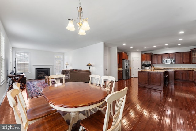 dining space featuring a chandelier and dark hardwood / wood-style flooring