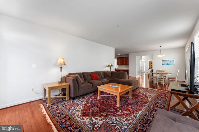 living room featuring hardwood / wood-style floors and an inviting chandelier