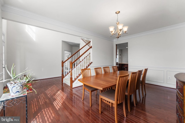 dining space featuring ornamental molding, a chandelier, and dark hardwood / wood-style flooring