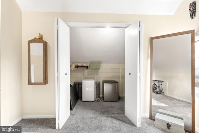 laundry area featuring carpet floors, washer and clothes dryer, laundry area, and baseboards