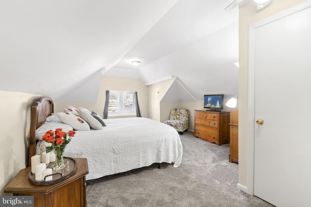 carpeted bedroom with vaulted ceiling